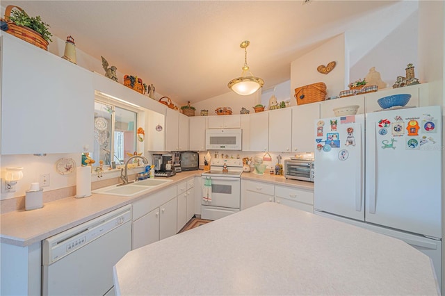 kitchen featuring white cabinetry, sink, hanging light fixtures, and white appliances