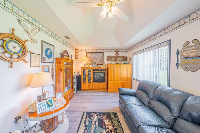 living room featuring ceiling fan, vaulted ceiling, and light wood-type flooring