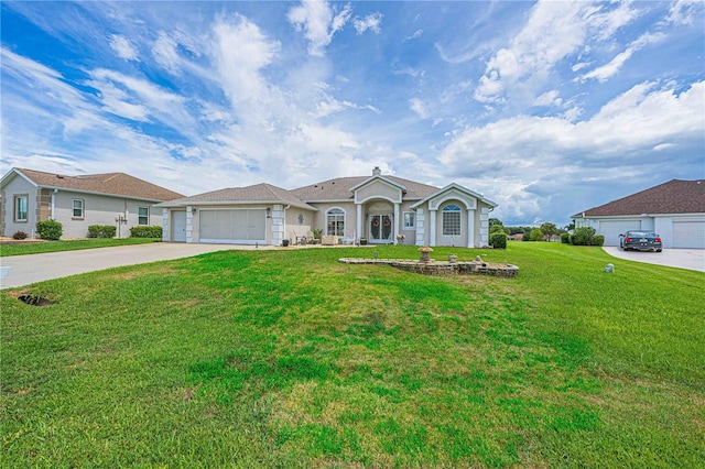 ranch-style house featuring a garage and a front lawn