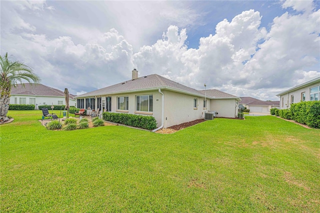 5495 NW 23rd Pl, Ocala, FL 34482 - back of house featuring a patio area, stucco siding, cooling unit, a chimney, and a lawn