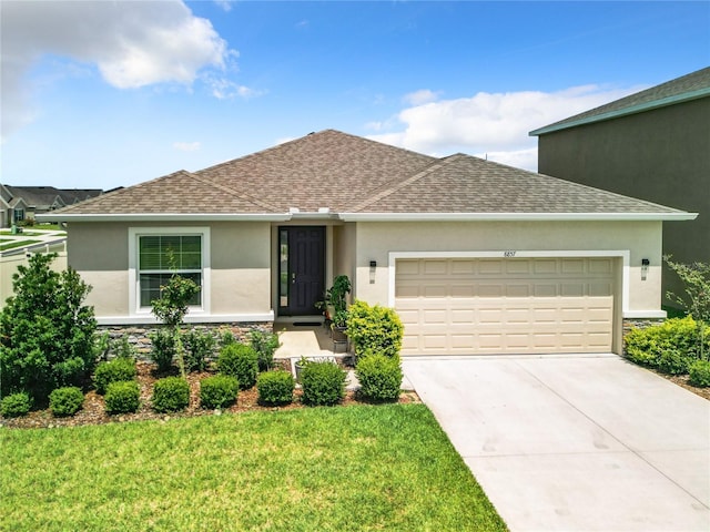 ranch-style house with a garage and a front lawn