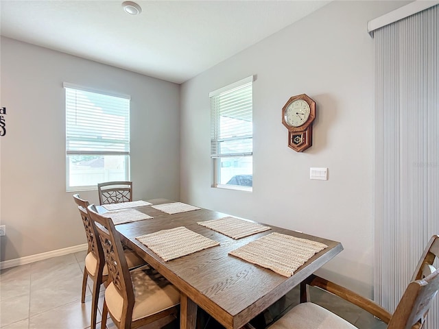 dining space featuring a wealth of natural light and light tile patterned floors