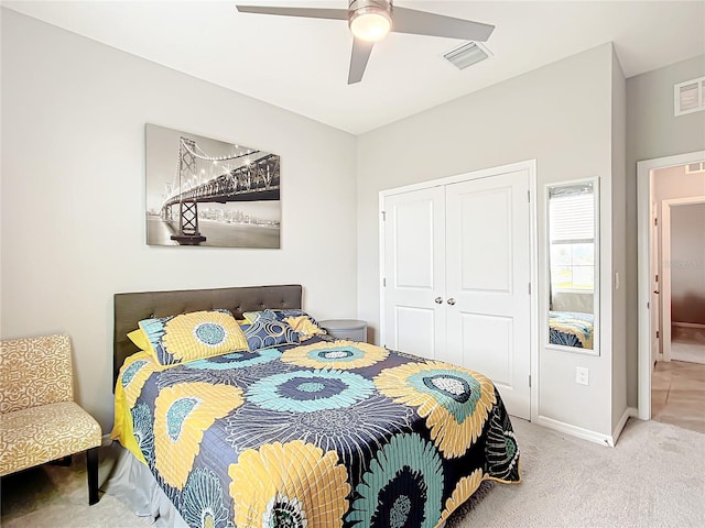 carpeted bedroom with ceiling fan and a closet