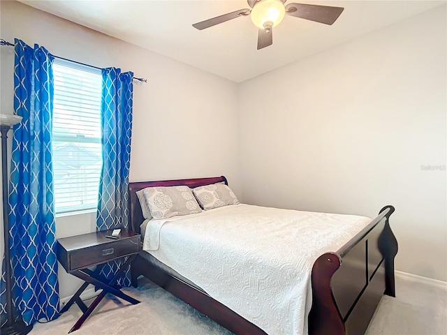 bedroom featuring light colored carpet and ceiling fan