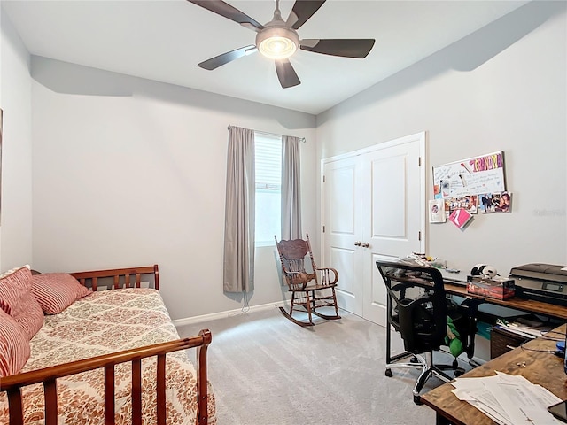 bedroom with ceiling fan, light colored carpet, and a closet