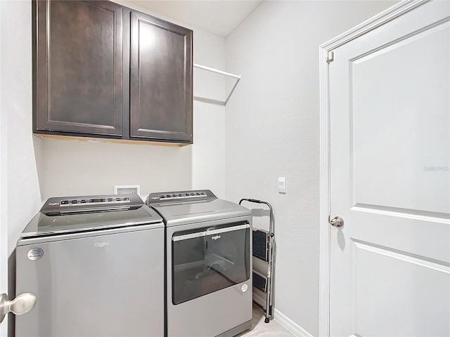 laundry room featuring cabinets and independent washer and dryer