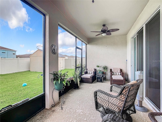 sunroom featuring ceiling fan