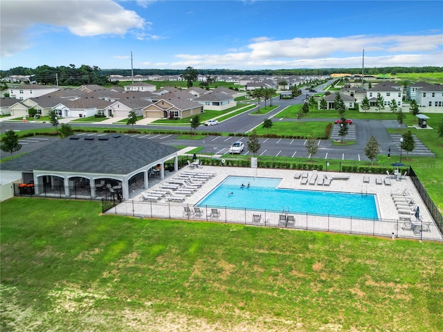 view of swimming pool featuring a yard