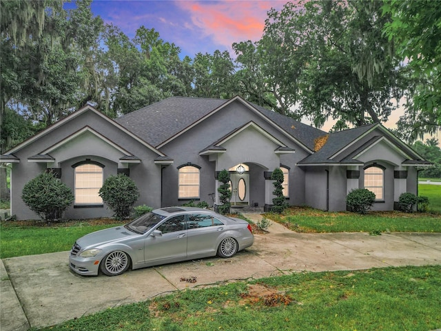 view of front of property with a lawn