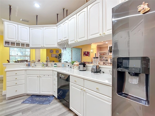 kitchen with dishwasher, stainless steel fridge, white cabinetry, and sink