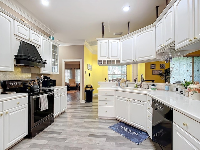 kitchen with black appliances, white cabinetry, sink, and ornamental molding