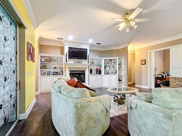 living room with crown molding, built in features, ceiling fan, and dark wood-type flooring