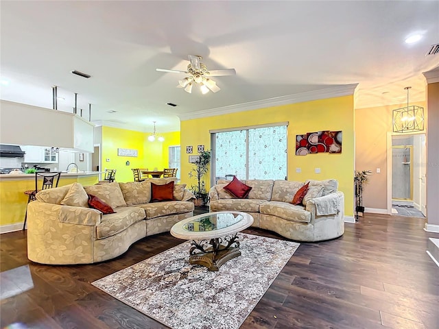 living room featuring crown molding, sink, dark hardwood / wood-style floors, and ceiling fan with notable chandelier