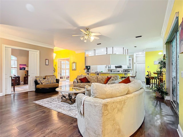 living room with ceiling fan, dark hardwood / wood-style floors, and crown molding