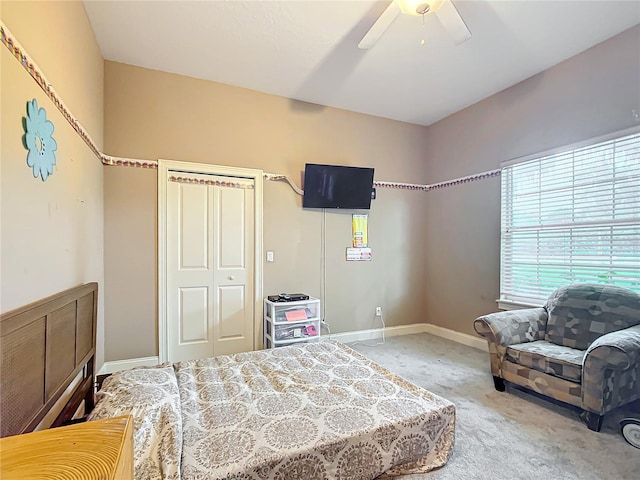 bedroom with ceiling fan, a closet, and carpet floors