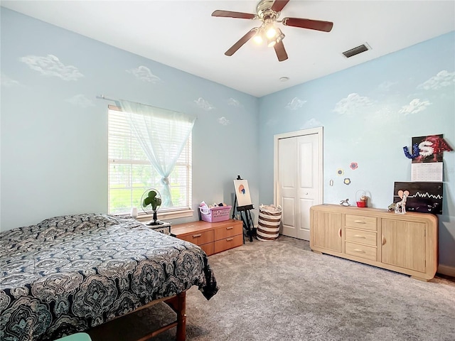 carpeted bedroom featuring a closet and ceiling fan