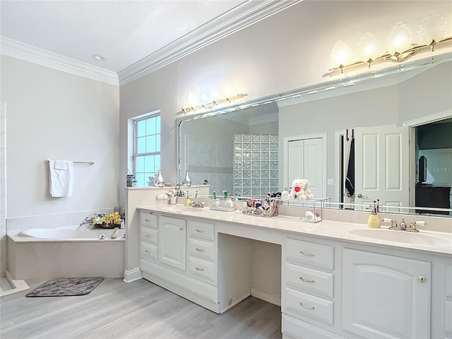 bathroom with vanity, crown molding, wood-type flooring, and a tub to relax in