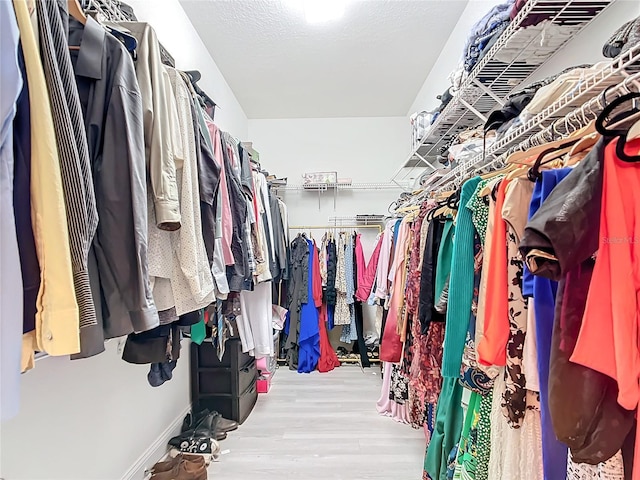 walk in closet with wood-type flooring