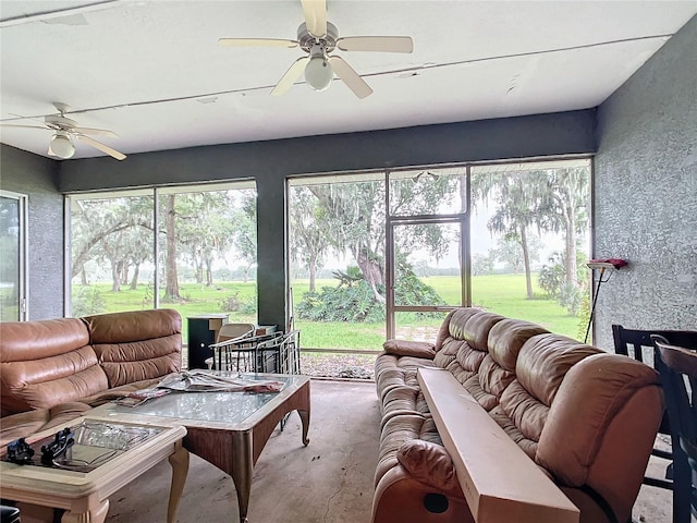 sunroom / solarium featuring ceiling fan