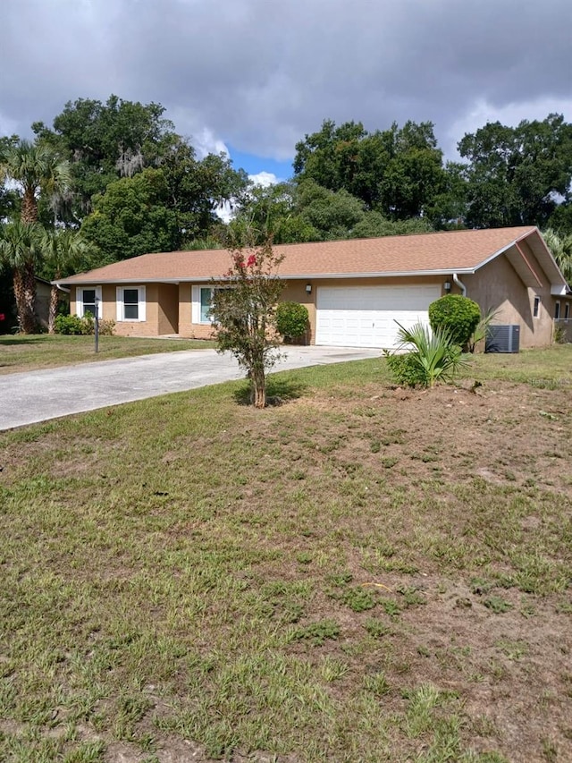 ranch-style home featuring a front yard and a garage