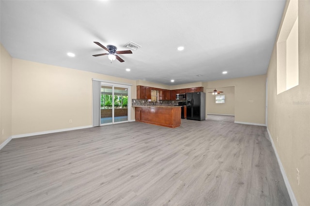 unfurnished living room with ceiling fan and light hardwood / wood-style floors