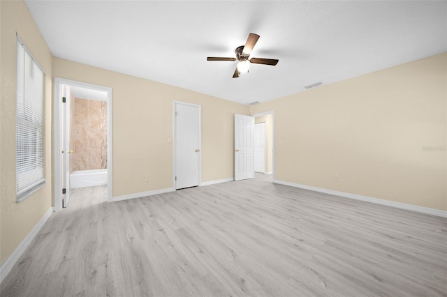 unfurnished bedroom with ensuite bathroom, ceiling fan, and light hardwood / wood-style flooring