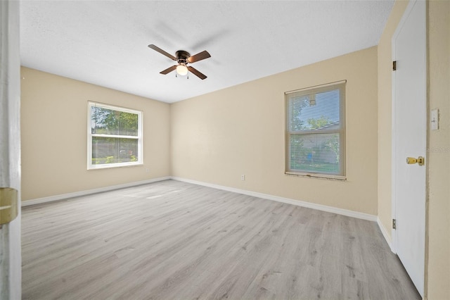 empty room with ceiling fan and light wood-type flooring