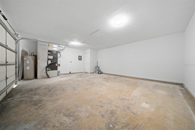 garage featuring heating unit and electric water heater