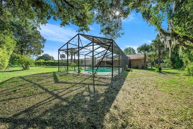 view of yard with glass enclosure