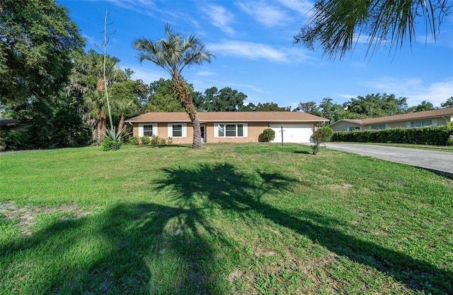 ranch-style home featuring a front lawn and a garage