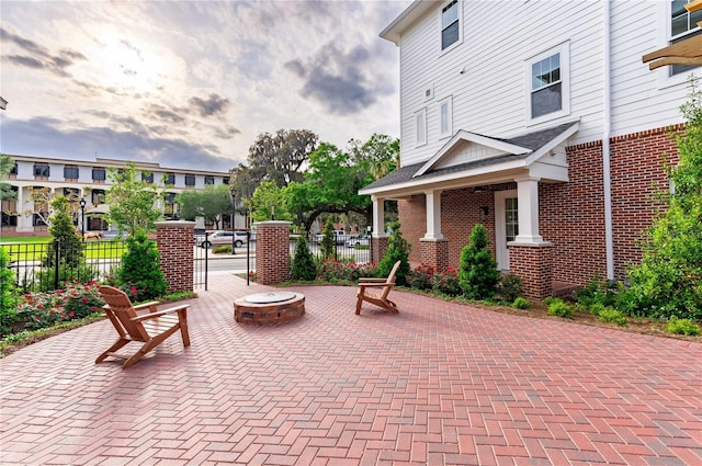 patio terrace at dusk featuring an outdoor fire pit