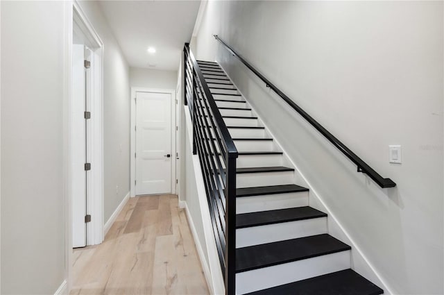 staircase with hardwood / wood-style flooring