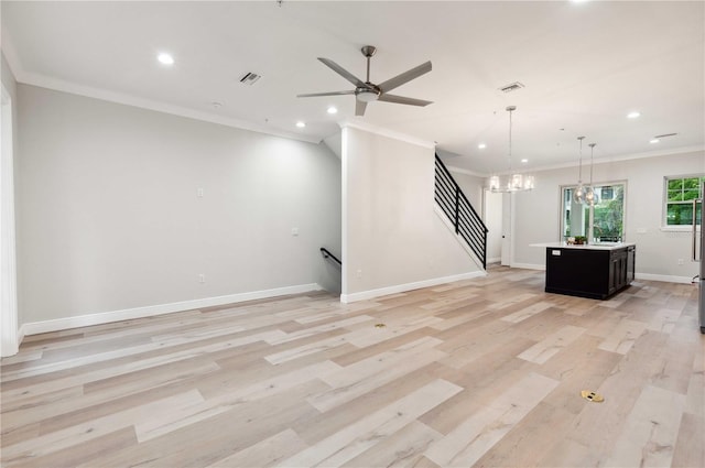 unfurnished living room with light hardwood / wood-style floors, ceiling fan with notable chandelier, and ornamental molding