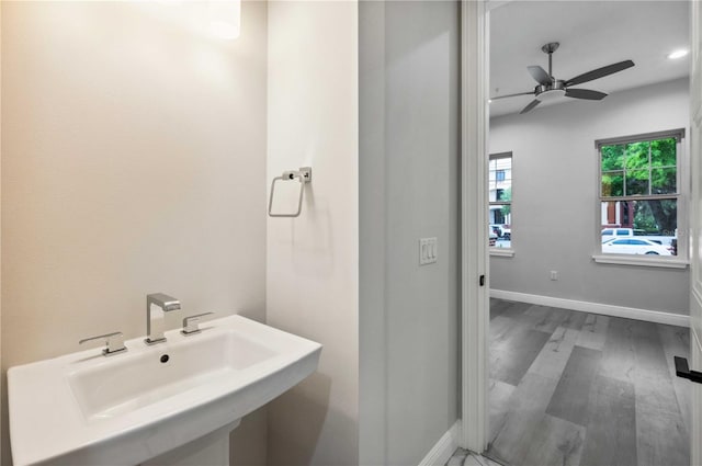 bathroom with hardwood / wood-style flooring, ceiling fan, and sink