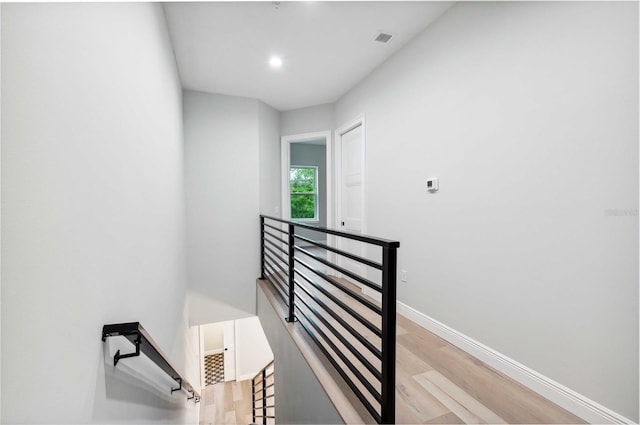 stairs with hardwood / wood-style floors