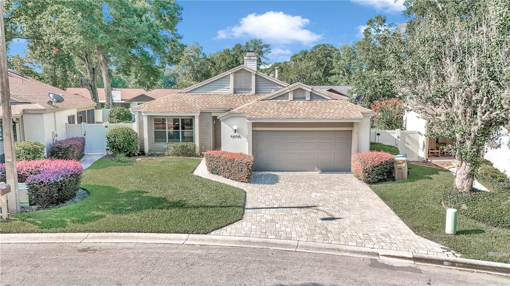 view of front of home with a garage and a front lawn