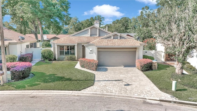 view of front of home with a garage and a front lawn