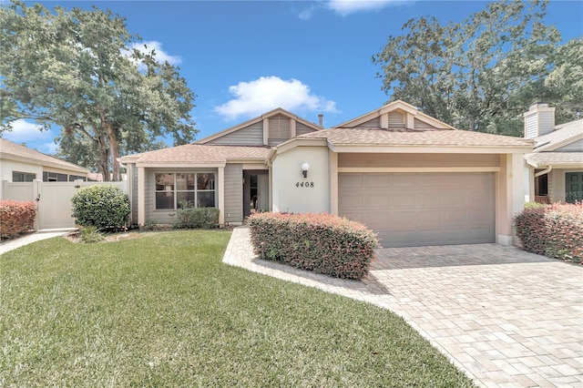 view of front of house featuring a garage and a front lawn