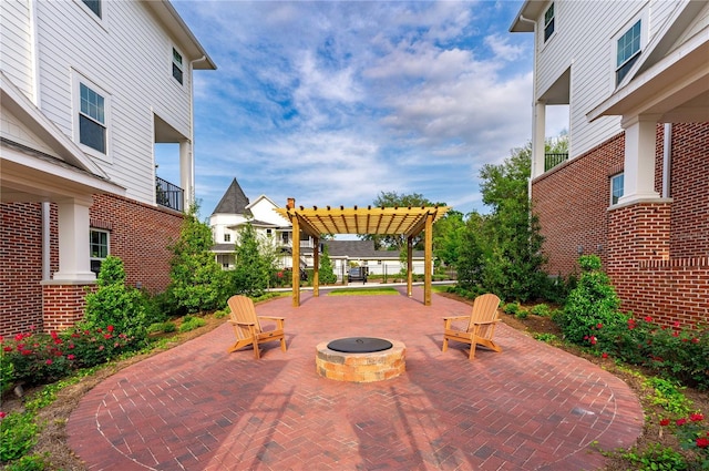 view of patio with a pergola and an outdoor fire pit