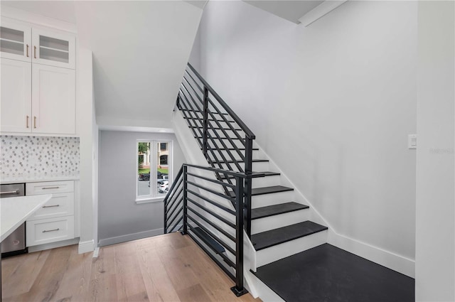 stairway with hardwood / wood-style floors