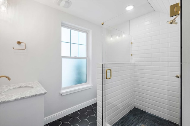 bathroom featuring vanity and a shower with shower door