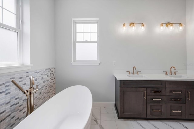 bathroom with vanity and a tub