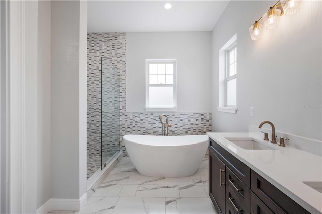 bathroom with plus walk in shower, vanity, and tile walls