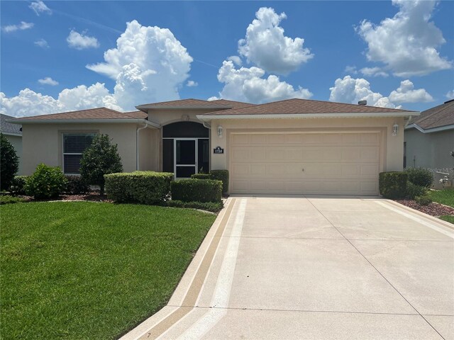 view of front of home featuring a garage and a front yard