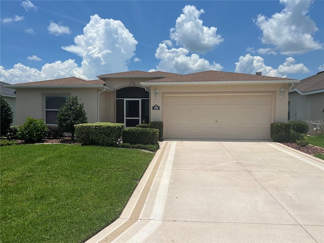 view of front of home featuring a garage and a front lawn