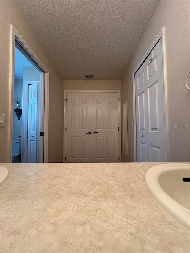 bathroom featuring a textured ceiling