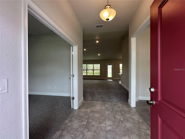 hallway with tile patterned flooring