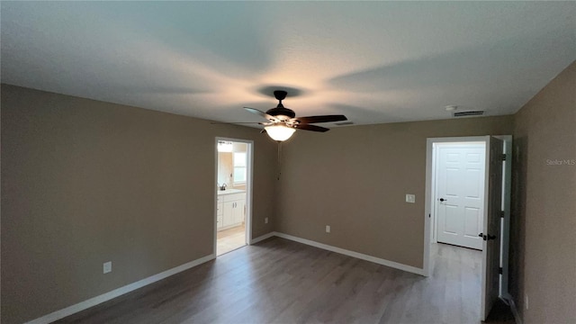 empty room featuring hardwood / wood-style floors and ceiling fan