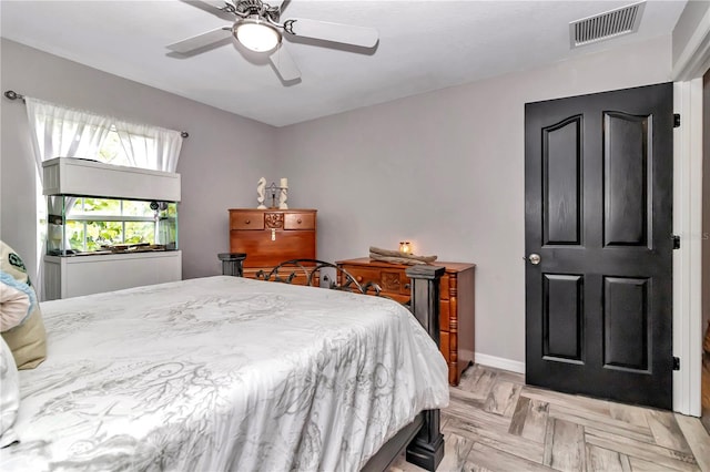 bedroom featuring ceiling fan and light parquet floors