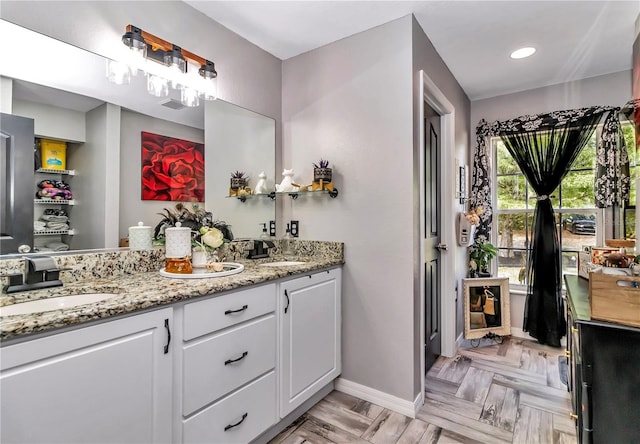 bathroom with vanity and parquet floors